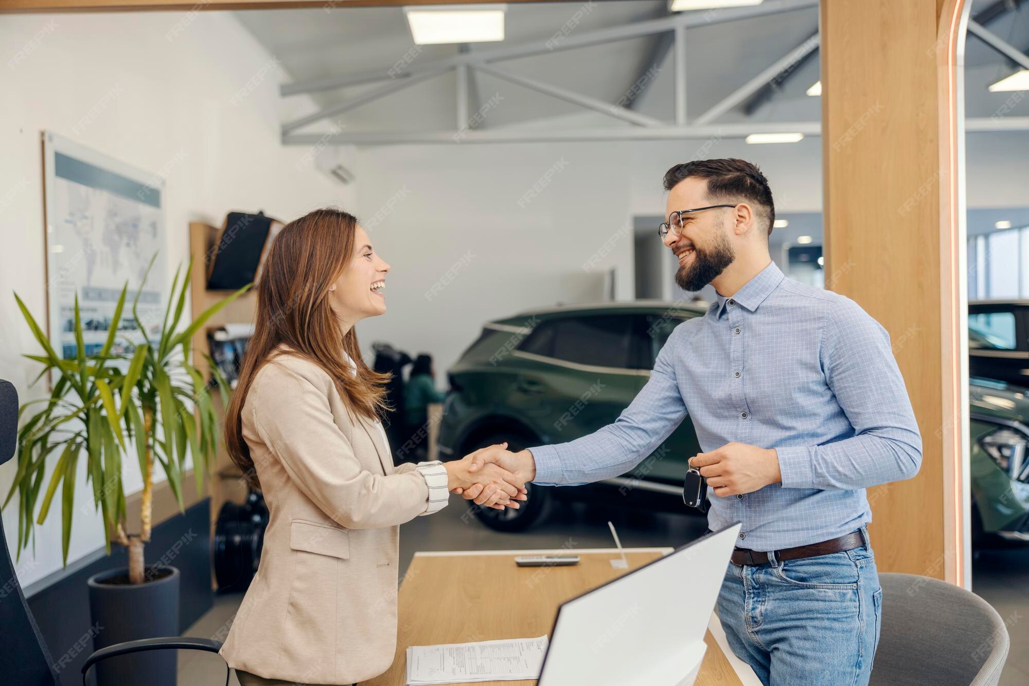 Happy first-time car buyer at dealership